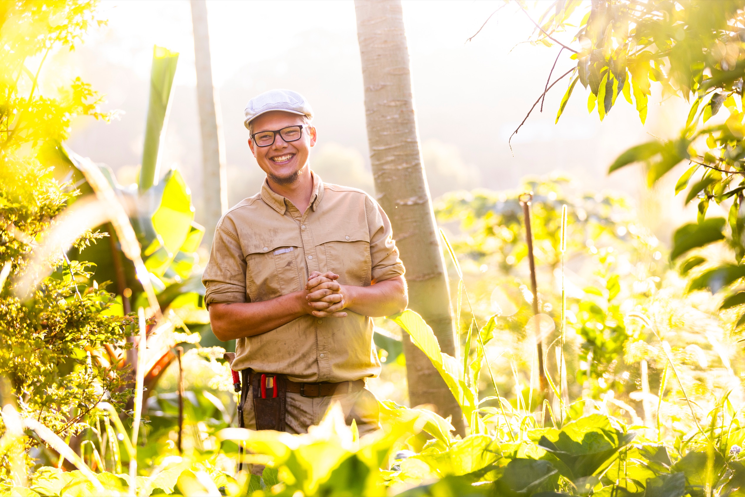 Sam Parker Davies smiling in a sunlit food garden
