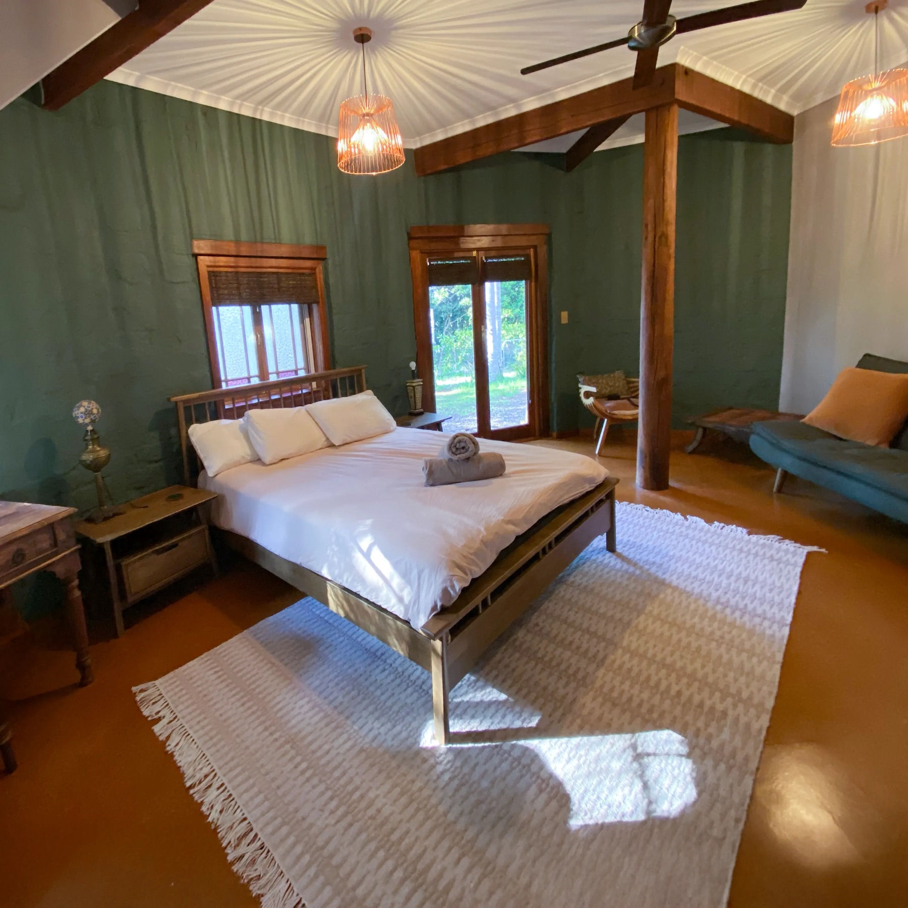 Bedroom with a double bed and green walls