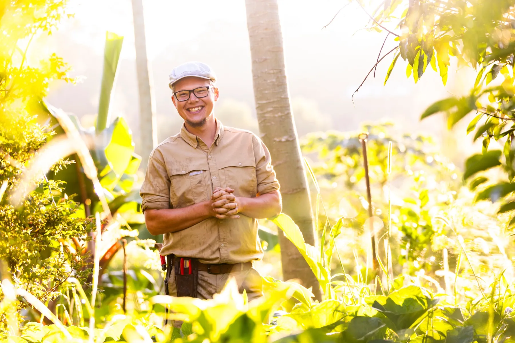 Sam Parker Davies smiling in a sunlit food garden