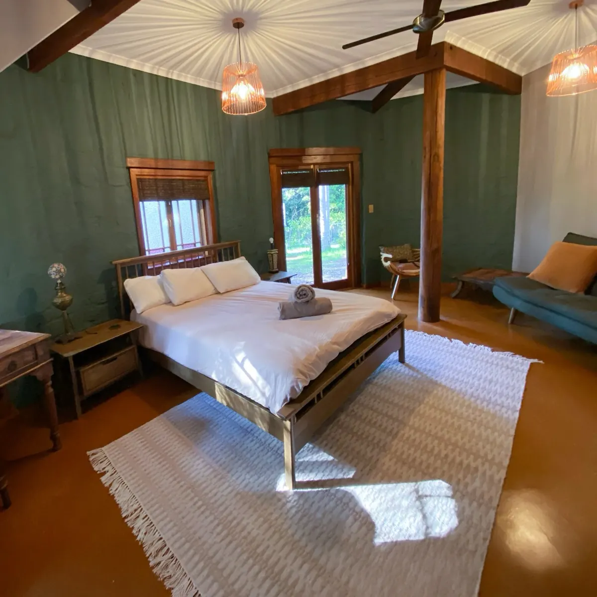 Bedroom with a double bed and green walls