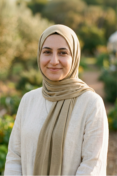 Woman in a beige headscarf in a garden